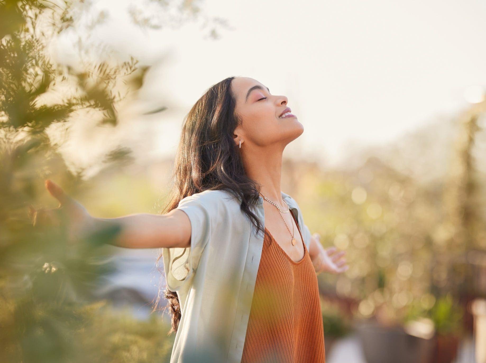 Woman enjoying the outdoors with arms outstretched.