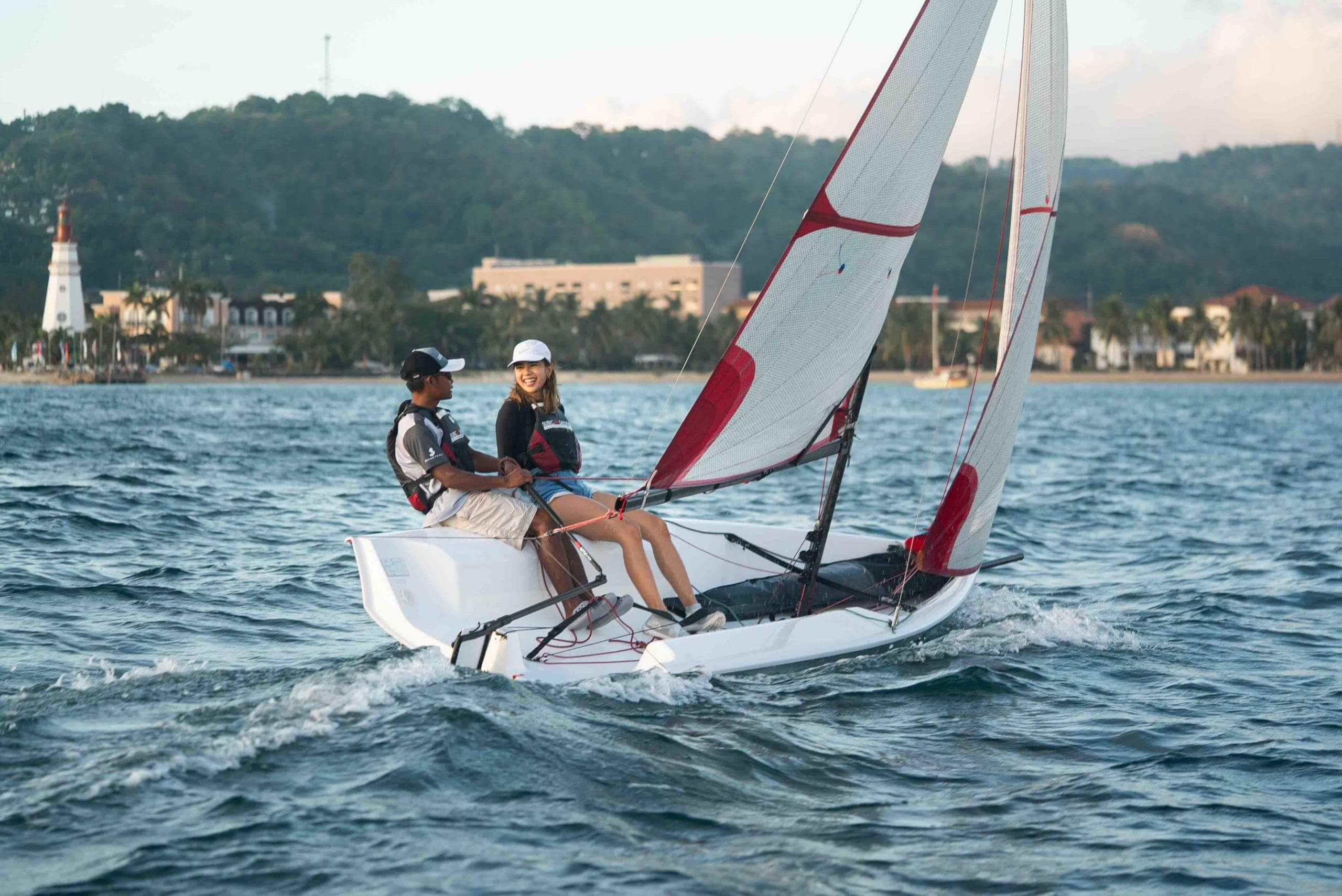 Two people sailing on a small boat.
